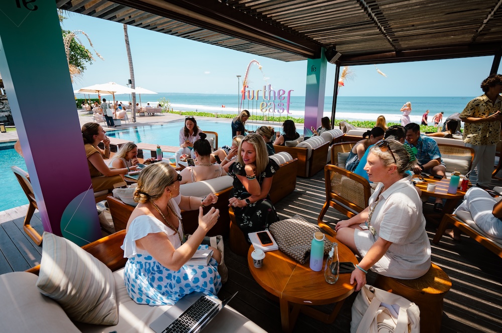 Group of attendees pool side in barefoot business attire 